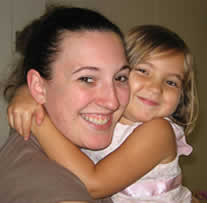 smiling student and child participant hugging