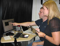 lab members looking at data on a computer monitor