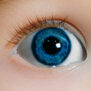 Close up photo of one blue eye of a child.